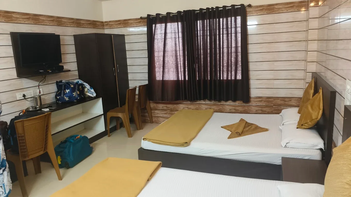 Guest room with television at Yamuna Vihar Tourist Home